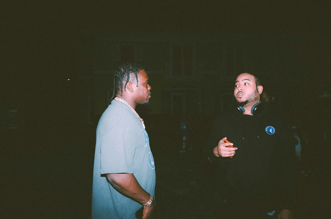 Producer calmly talking with a news presenter backstage